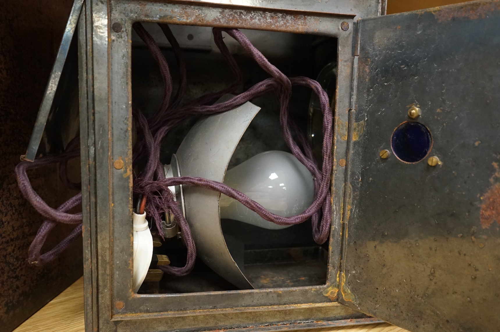 A tinplate and brass magic lantern, converted to an electric lamp and missing the original chimney, in a tin case, together with a case of slides, mostly biblical related.